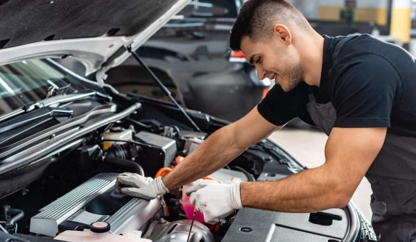 Mechanic checking engine oil